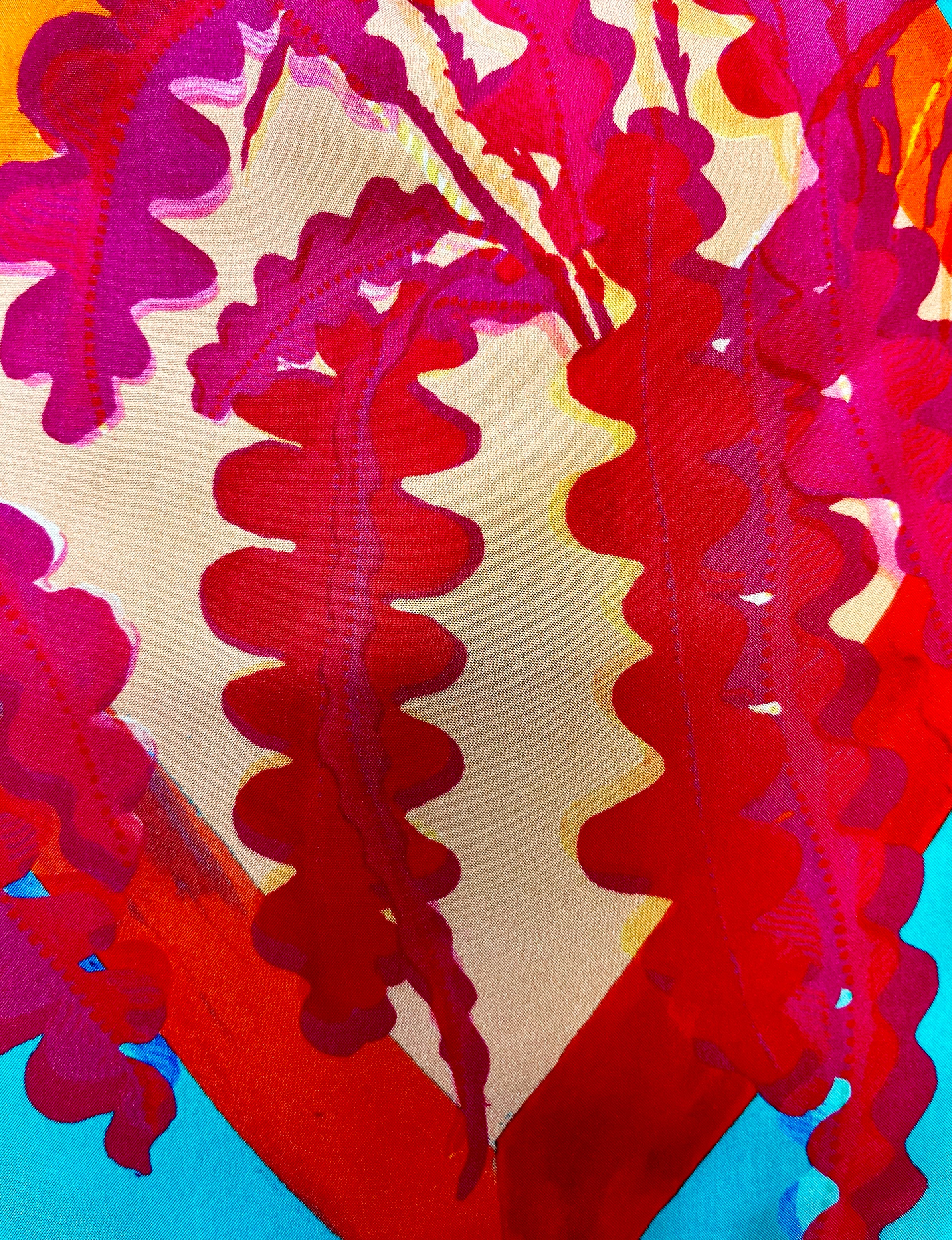 Eleni Malami luxury silk handbag with turquoise and fuchsia fringe, featuring a stylish, handcrafted design and vibrant color details.