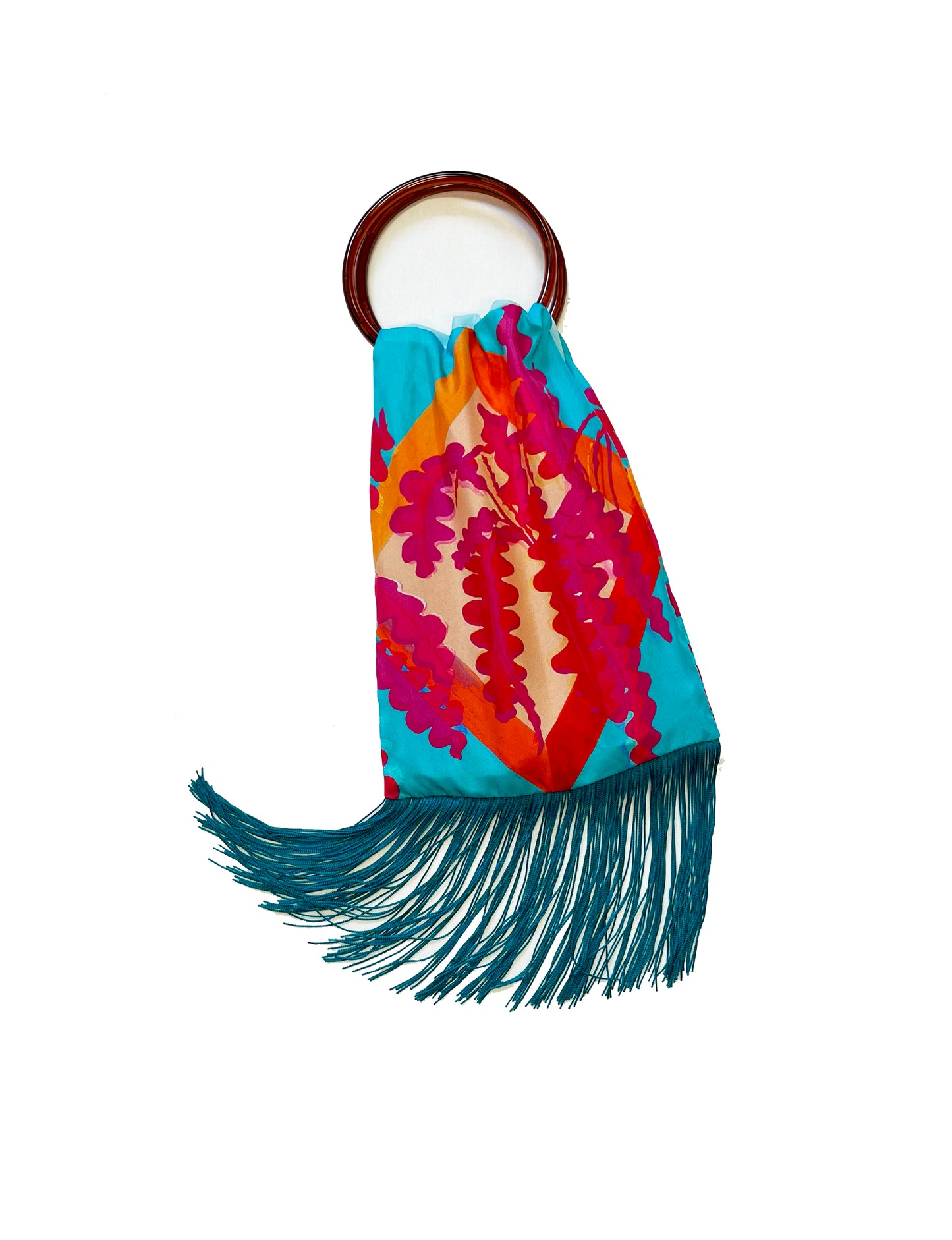 Colorful handbag with floral pattern and fringes on a white background