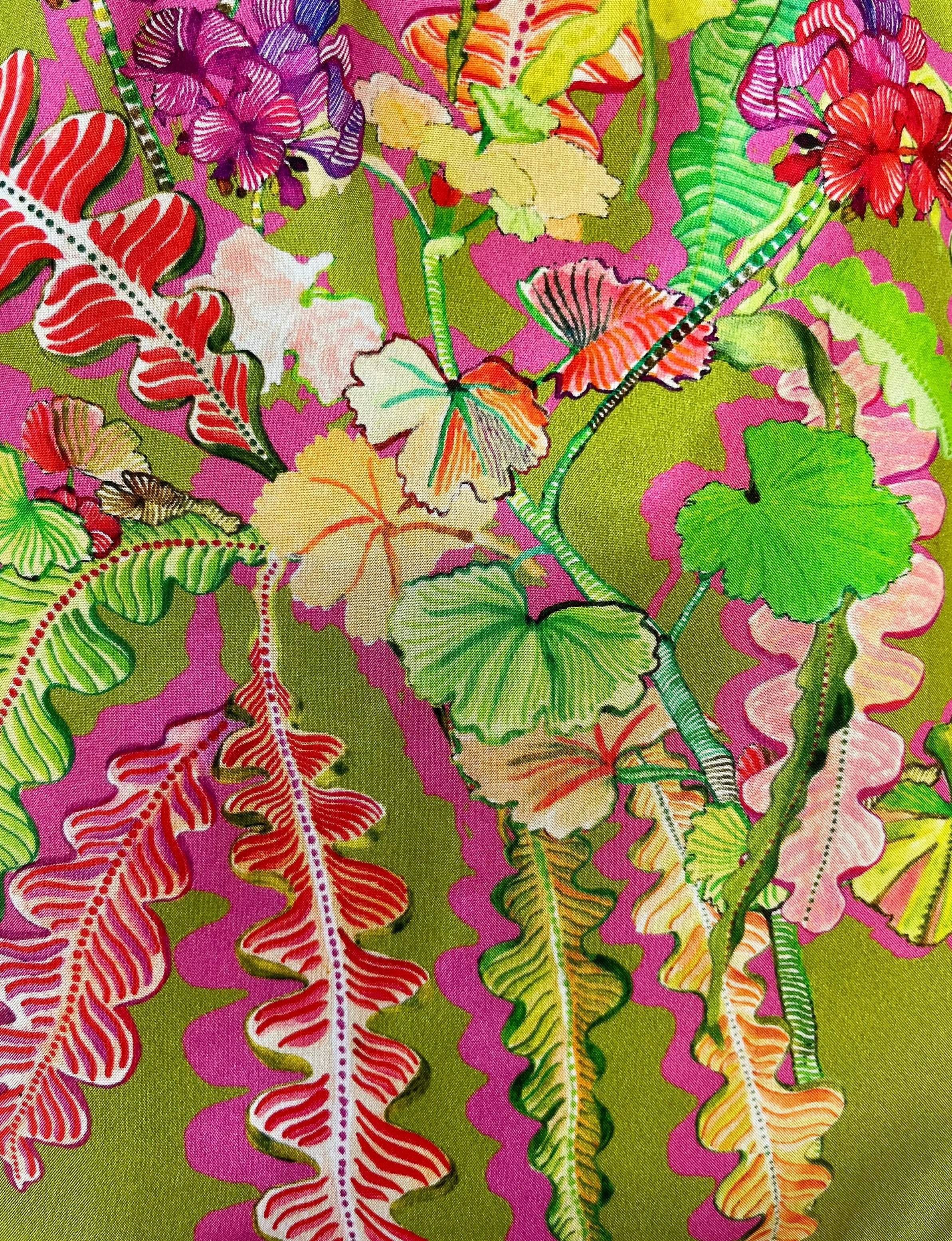 Eleni Malami luxury silk handbag with olive and magenta geranium floral design and elegant fringe detailing.