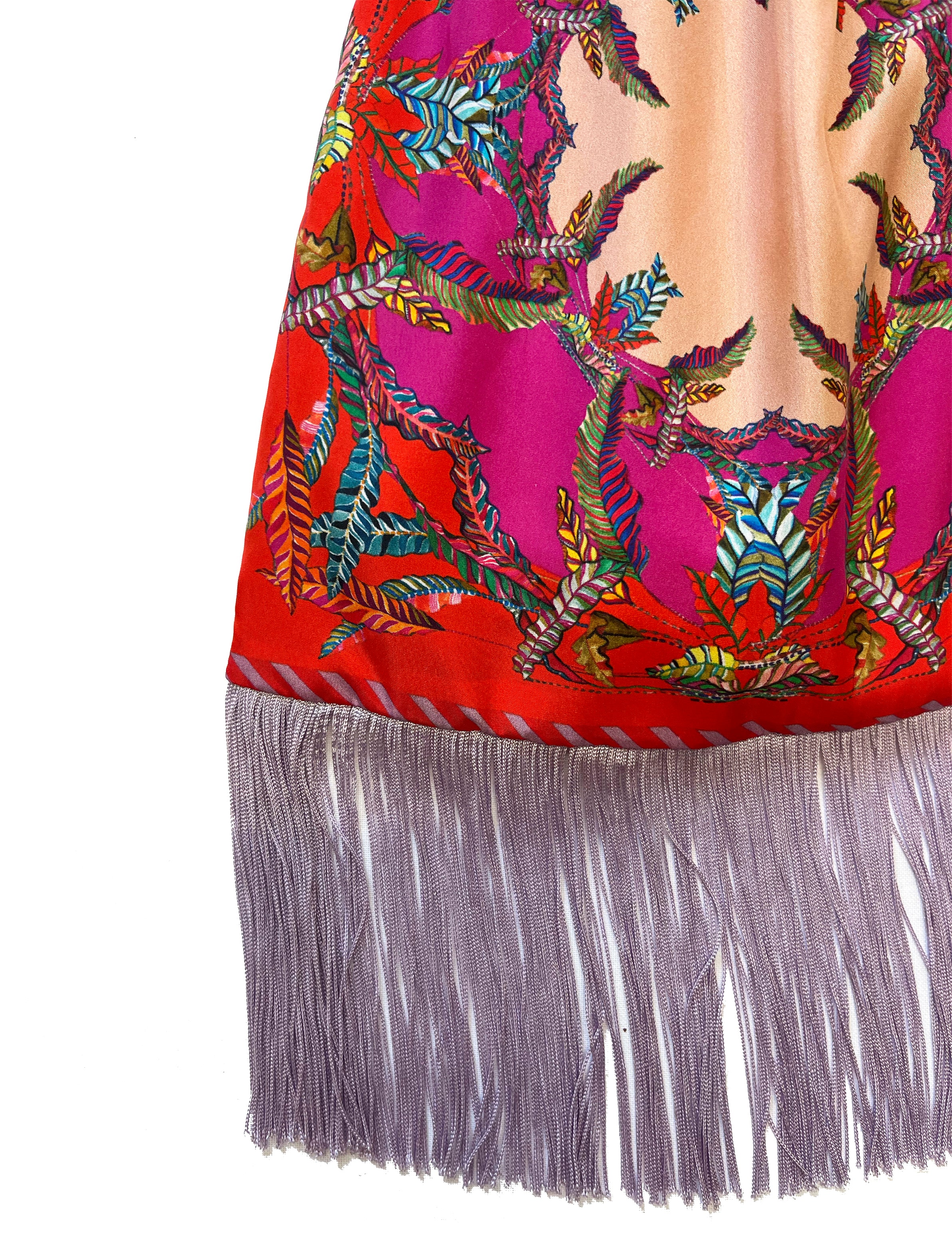 Large silk handbag by Eleni Malami with red and magenta fringe, featuring bamboo handles and luxurious design.